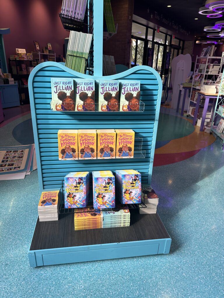 An end-cap display featuring all three of Nicole Collier Harp's published novels, showcasing editing and coaching resources in action.